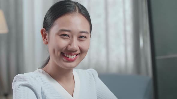 Asian Woman Engineer With The House Model Smiling To The Camera While Working On A Desktop At Home