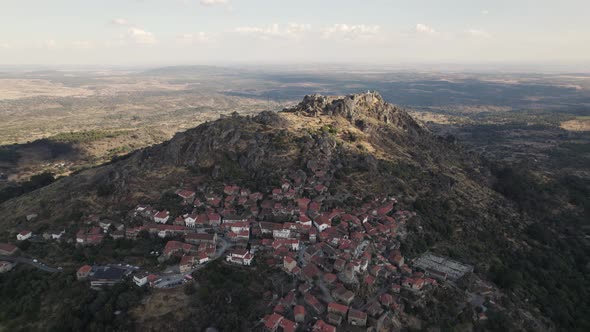 Mountaintop Monsanto village built in harmony with granite boulders; aerial