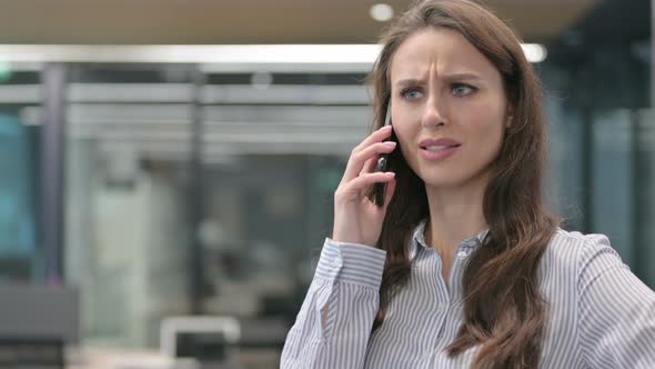 Portrait of Aggressive Young Businesswoman Angry on Smartphone