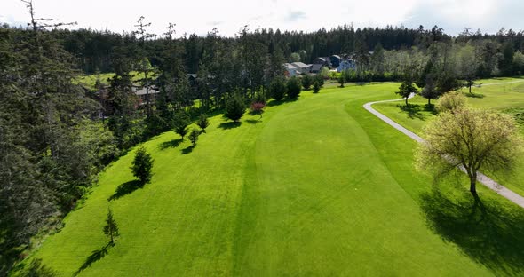 Aerial view of a driving range bordering a suburban neighborhood.