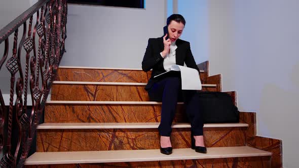 Woman Having a Phone Conversation on Staircase