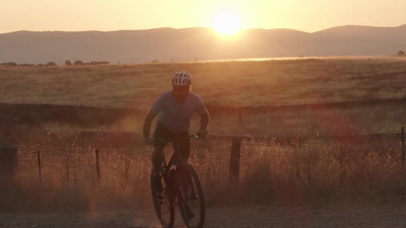 Male Mountain Biker Pedaling During a Sunrise in Nature