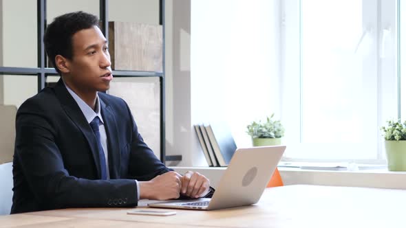 Black Businessman at Work Talking With Customer