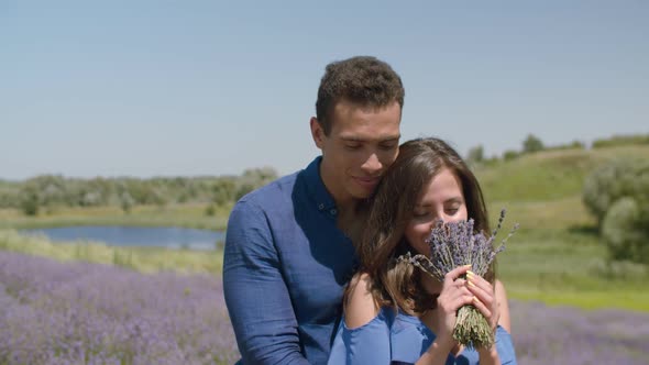 Loving Couple Bonding in Blooming Lavender Field