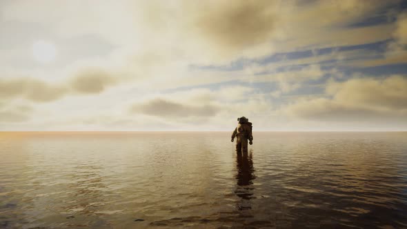 Spaceman in the Sea Under Clouds at Sunset