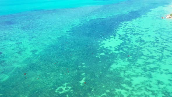 Sea texture, blue turquoise water with coral reef and white sand on the seafloor. flying over the tr