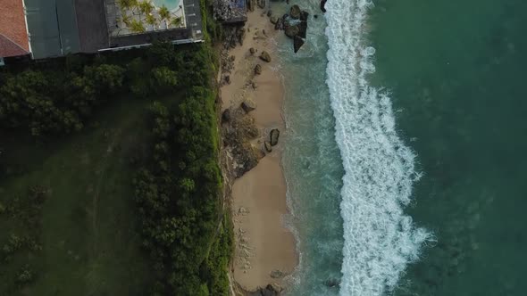 Beautiful Bingin beach with exotic cliffs houses and hotel located in Bali, Indonesia. This drone fo