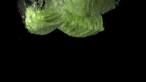 Super Slow Motion Chunks of Fresh Cabbage Fall Under the Water with Air Bubbles