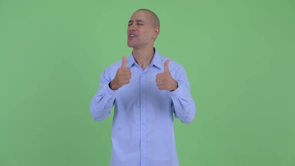 Happy Bald Multi Ethnic Businessman Giving Thumbs Up and Looking Excited