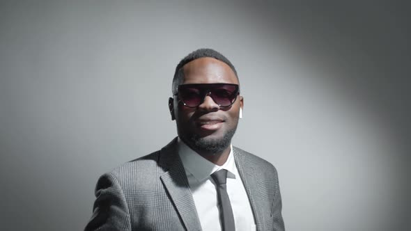 Studio Portrait of Cheerful Black Businessman in Sunglasses