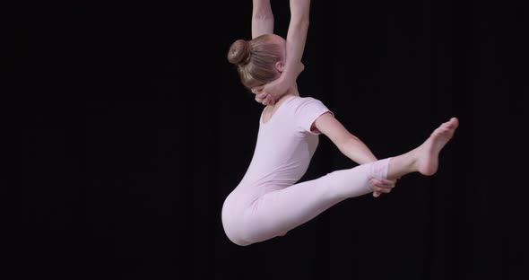 Footage of Two Girls Doing Aerial Gymnastics Holding and Doing Splits