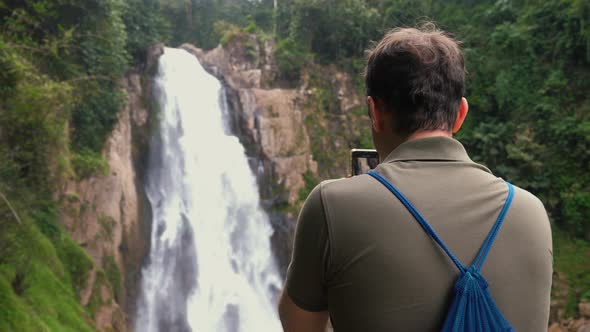 Blogger Man or Vlogger Recording Video of Beautiful Waterfall Video Shooting