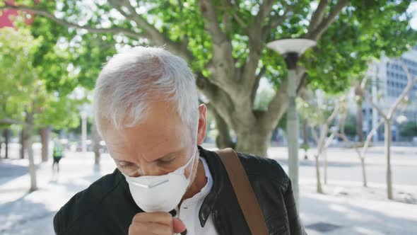 Caucasian man out and about in the street wearing on a face mask against coronavirus