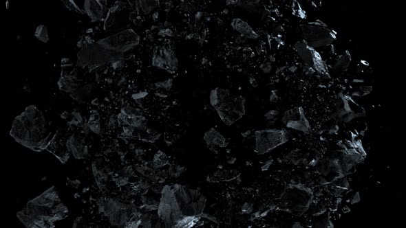 Super Slow Motion Shot of Rotating Exploded Scattered Coal on Black at 1000Fps