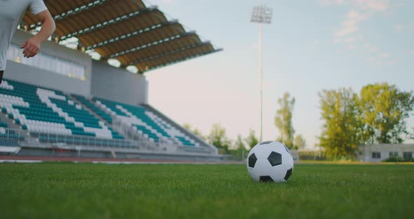 Close Up in Slow Motion Kicking a Soccer Ball in Athletic Cleats