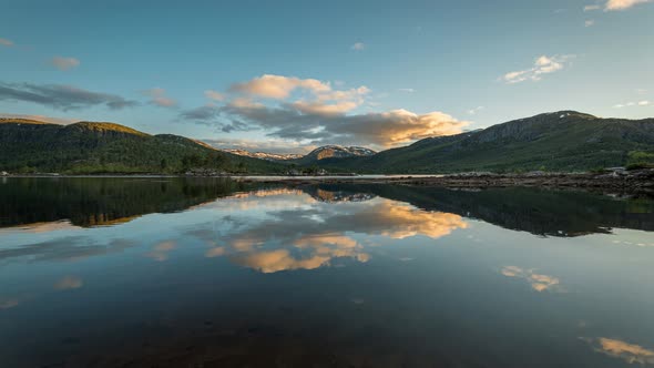 Timelapse over a Lake in Norway, with clouds and Sunset at the End. alt