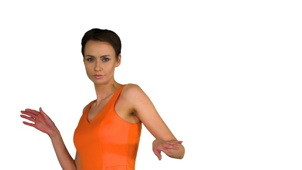 Short-haircutted pretty woman dancing in orange sundress