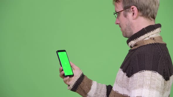 Profile View of Happy Handsome Man Using Phone