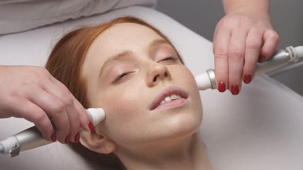 Close-up of a Woman's Face and Hands of a Cosmetologist Doing a Hardware Procedure for Facial Skin