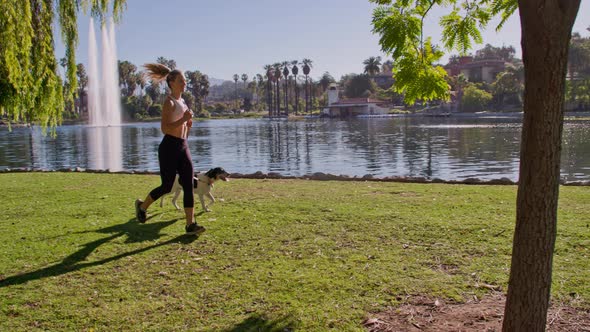 Attractive Woman Jogging With Her Dog