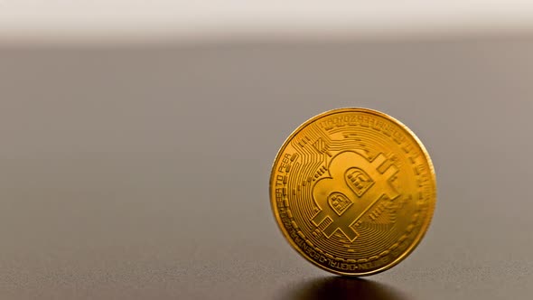 Bitcoin Coin Spinning on Gray Background  Closeup with Slowmo