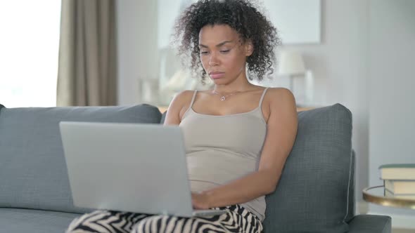Smiling African Woman Coming and Starting Laptop Work on Sofa
