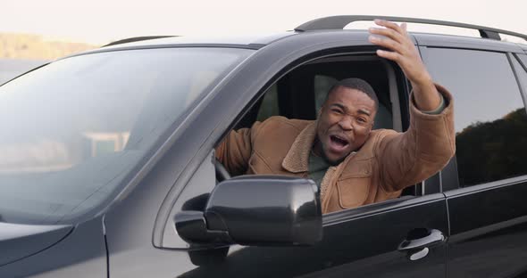 Angry Black Driver Behind the Wheel of a Car