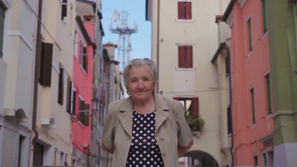 Old Woman Traveler Walks About Streets in Chioggia