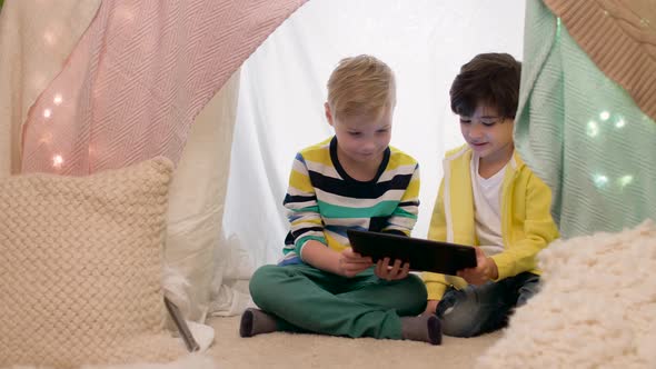 Little Boys with Tablet Pc in Kids Tent at Home