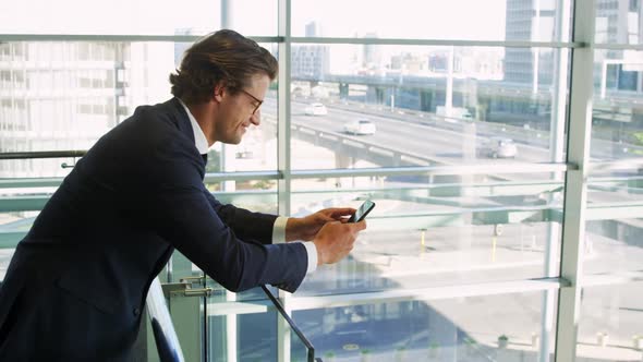 Businessman using smartphone in modern office building