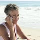 Senior woman using cell phone on beach - VideoHive Item for Sale
