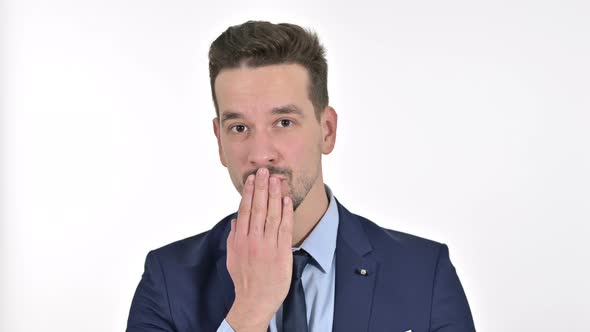 Portrait of Attractive Young Businessman Giving Flying Kiss, White Background