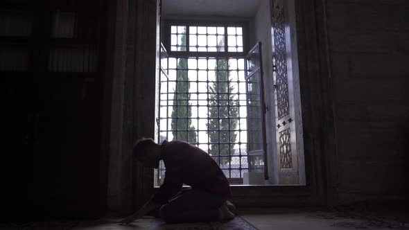 Muslim youth performing his worship in the mosque. alt