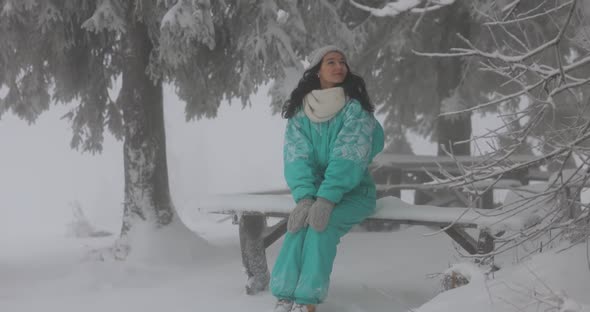 Woman in Ski Suit in Snowy Forest During Winter Vacations Outdoors