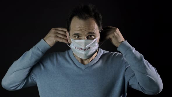 Covid-19 Concept, Man Puts on Facial Mask, Lockdown, Quarantine Restrictions