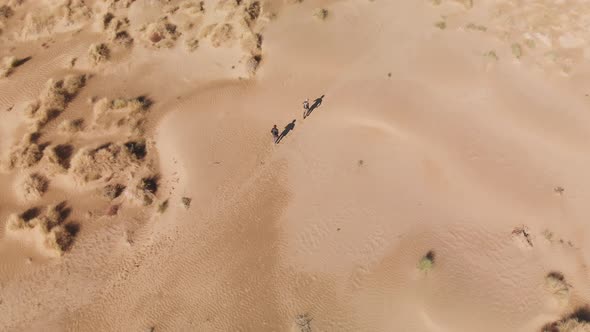 Aerial Shot of People Running at Sand Dunes in Kazakhstan