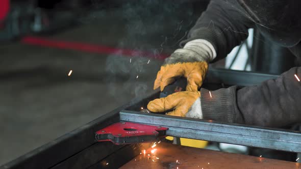 Footage of a Man Work with Grinding a Sheet of Metal / Videohive
