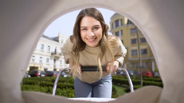 Beautiful Smiling Mother Admiring Baby Swinging Stroller, Motherhood Infant Pov