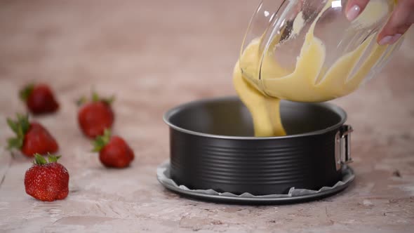 Woman Hands Pouring the Batter into the Pan.	