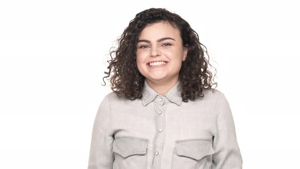 Portrait of Surprised Joyful Woman with Curly Hair Touching Her Head and Not Believe in Her