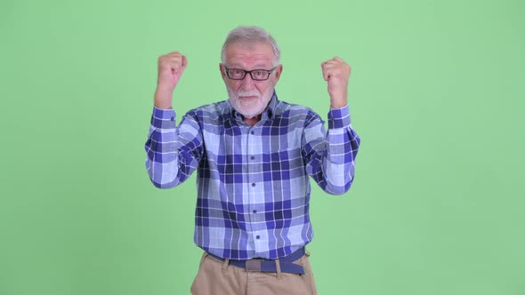 Happy Senior Bearded Hipster Man Getting Good News