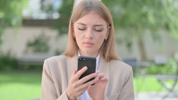 Outdoor Young Businesswoman Browsing on Smartphone