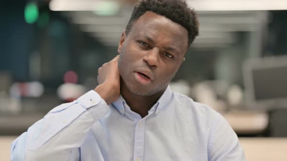 Portrait of African Businessman Having Neck Pain