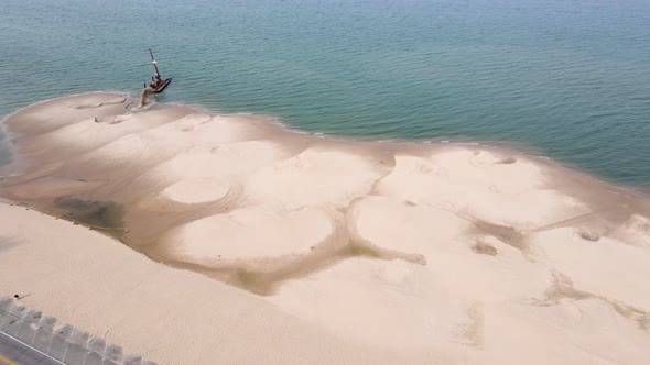 Spinning slowly around a ship dredging sand in summer.