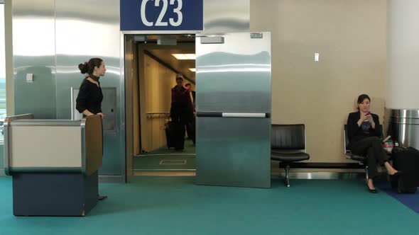 Airport passengers walk out of jet way door