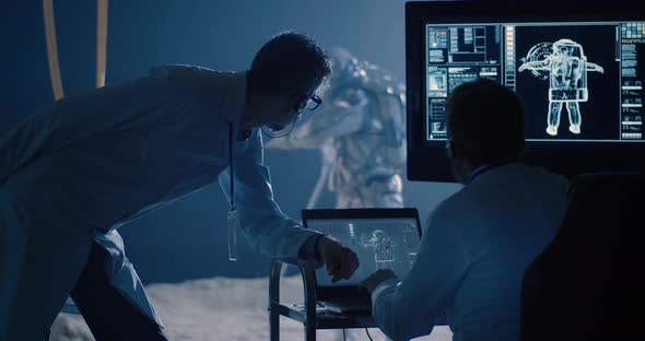 Astronaut and Scientists Testing Spacesuit Mobility alt