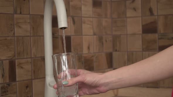 a Person Pours Clean Clear Tap Water Into a Glass Slow Motion