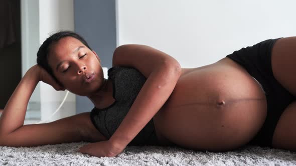 Close Up of Young Pregnant Woman Doing Leg and Breathing Exercise at Home