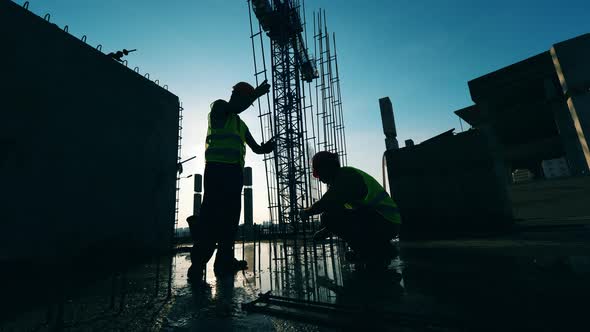 Metal Framework of the Building Is Being Constructed By Workers