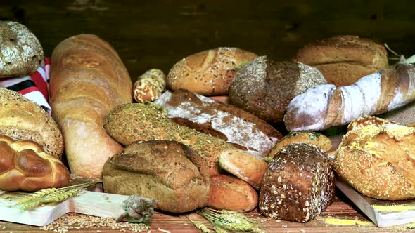 Bread, Breads, Buns on a Dark Background of Wood